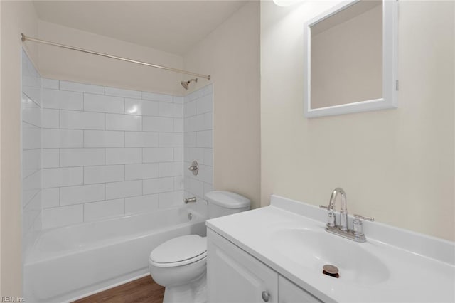 full bathroom with toilet, vanity, wood-type flooring, and tiled shower / bath