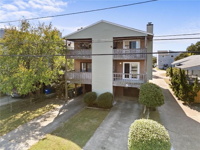 view of front of property with a balcony and a carport