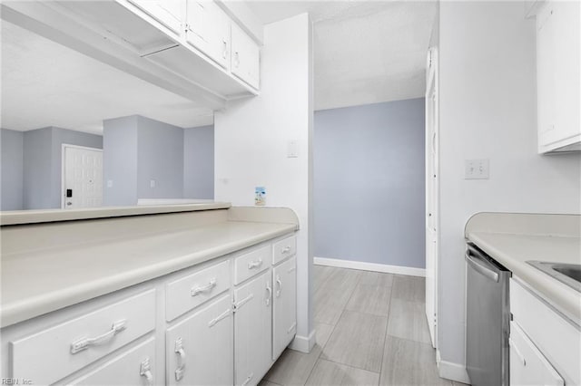 kitchen with dishwasher and white cabinetry