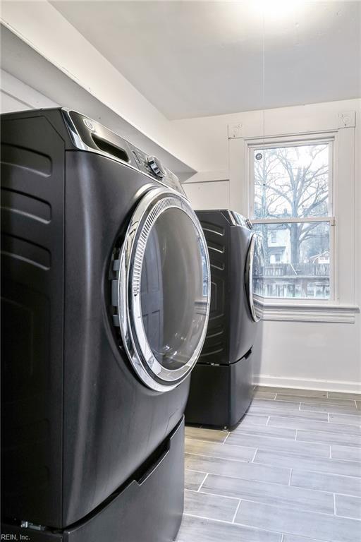 washroom with separate washer and dryer and a wealth of natural light