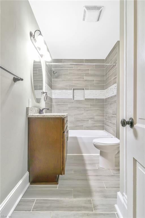 full bathroom with vanity, toilet, and tiled shower / bath