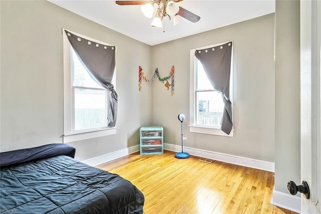 bedroom with ceiling fan and hardwood / wood-style flooring