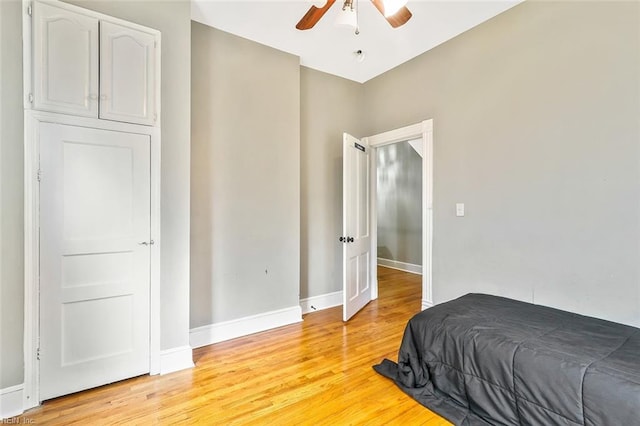 bedroom with light wood-type flooring and ceiling fan