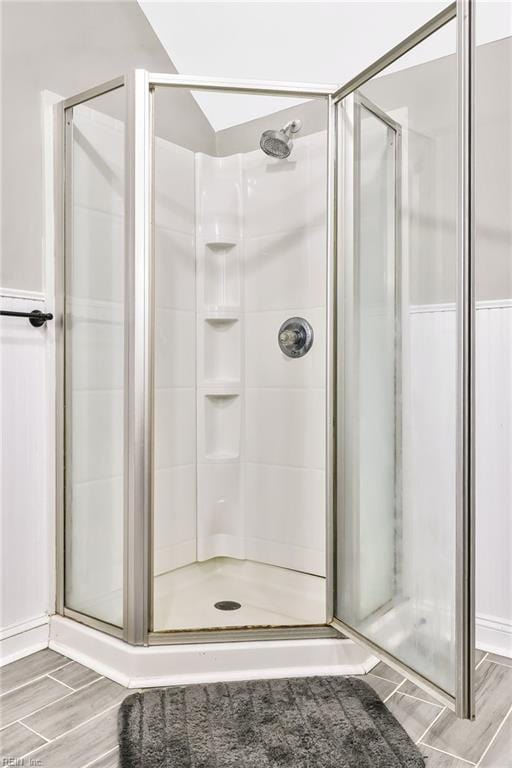 bathroom featuring a shower with shower door