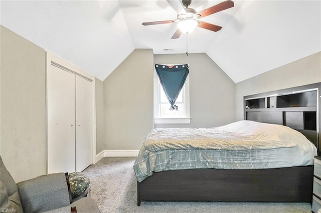 carpeted bedroom with ceiling fan and vaulted ceiling