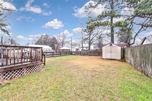 view of yard featuring a shed and a wooden deck