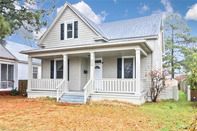 view of front of house featuring a porch and a front yard