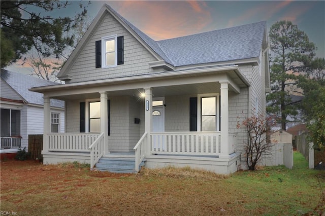 view of front of home featuring a porch and a yard