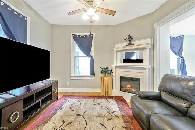 living room featuring light hardwood / wood-style floors and ceiling fan