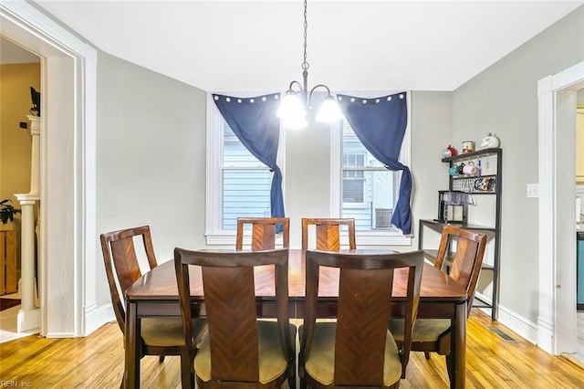 dining room featuring a chandelier and light hardwood / wood-style flooring