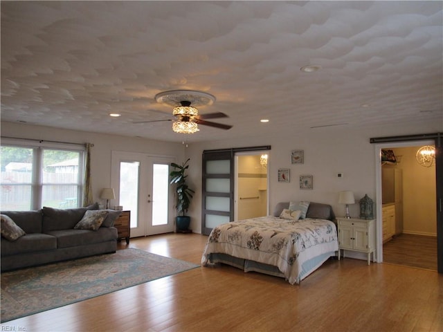 bedroom with french doors, light hardwood / wood-style floors, ceiling fan, and access to outside