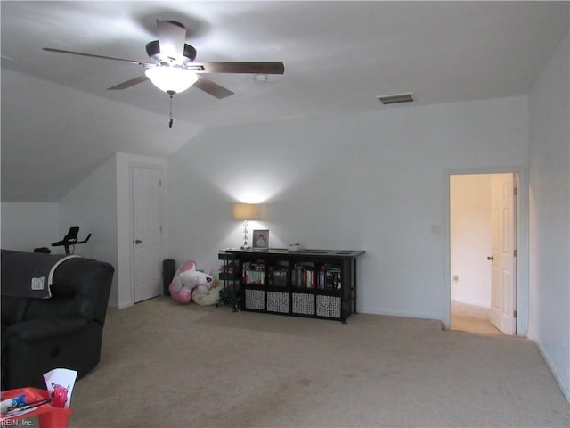 interior space featuring ceiling fan, light colored carpet, and lofted ceiling