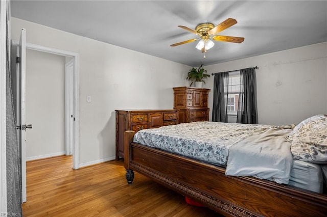 bedroom with ceiling fan and light hardwood / wood-style floors