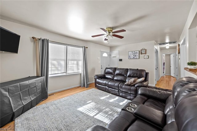 living room with light wood-type flooring and ceiling fan