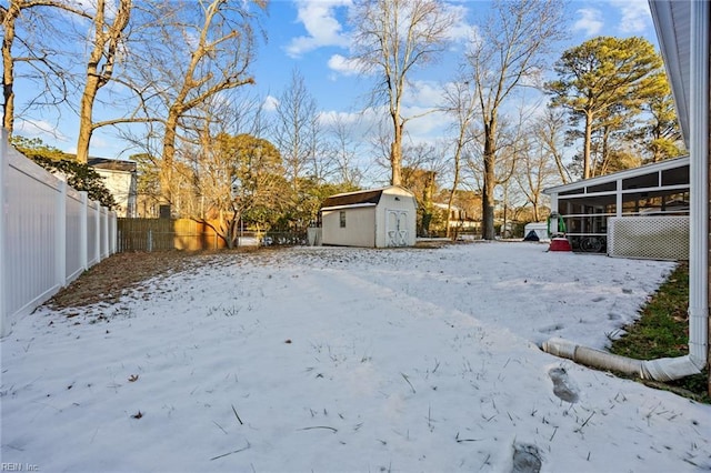 snowy yard with a shed