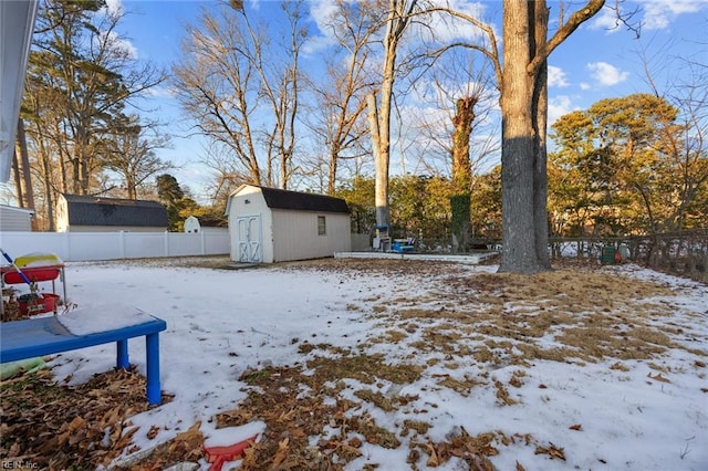 snowy yard with a shed