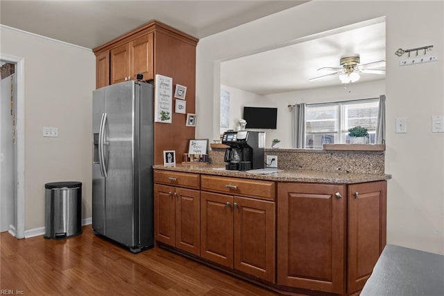 kitchen featuring stainless steel fridge, ceiling fan, and dark hardwood / wood-style floors