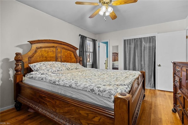 bedroom with ceiling fan and wood-type flooring