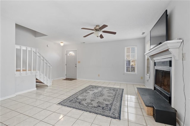 interior space featuring light tile patterned floors and ceiling fan