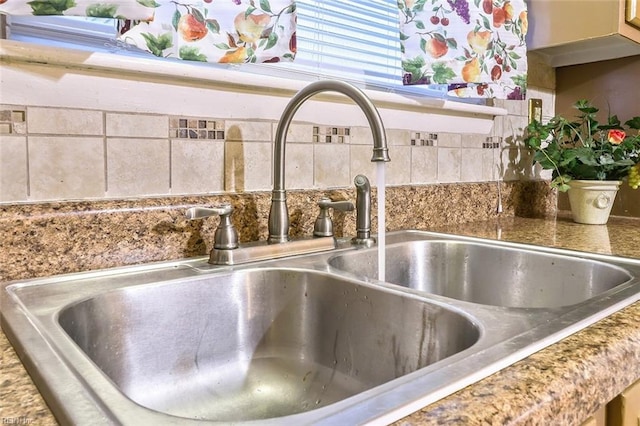 details featuring decorative backsplash and sink