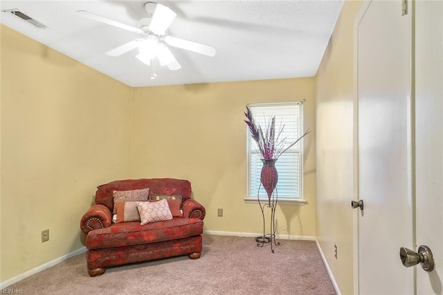 sitting room with ceiling fan and carpet floors