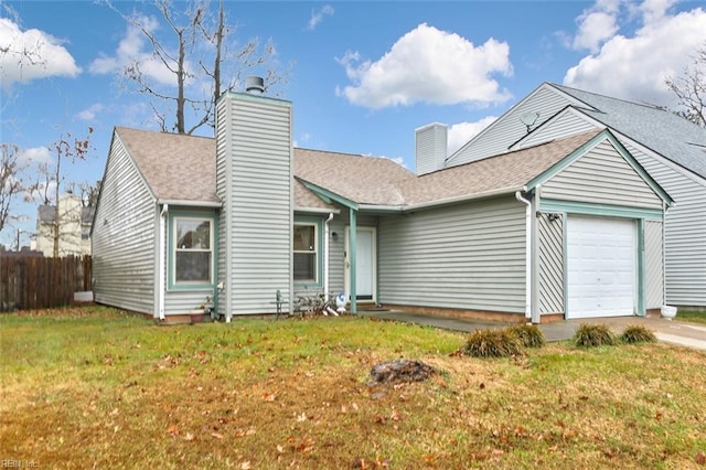 view of front of home with a front yard and a garage