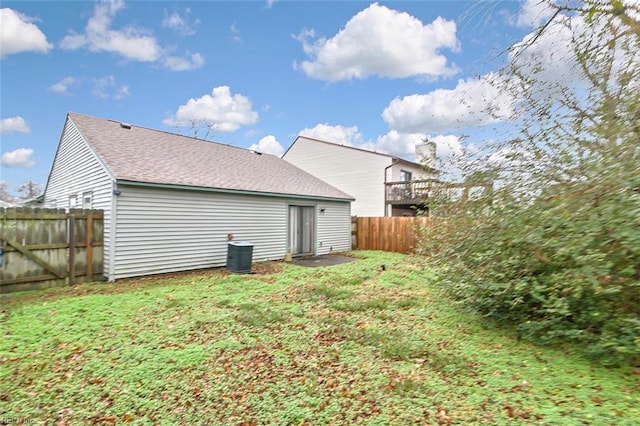 back of house with a lawn