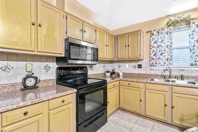 kitchen with light stone countertops, sink, black / electric stove, decorative backsplash, and light tile patterned floors