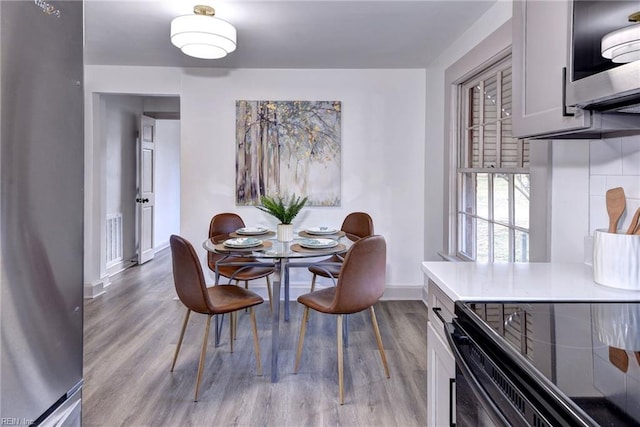 dining space with light hardwood / wood-style floors