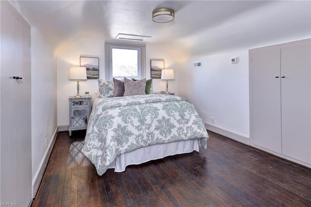 bedroom with dark hardwood / wood-style flooring and vaulted ceiling