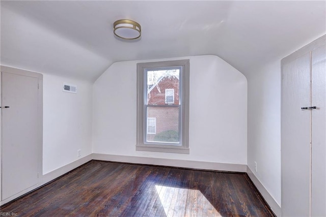 bonus room featuring dark hardwood / wood-style floors and lofted ceiling