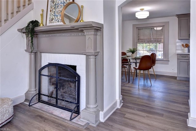 interior details with decorative backsplash, a fireplace, and hardwood / wood-style floors