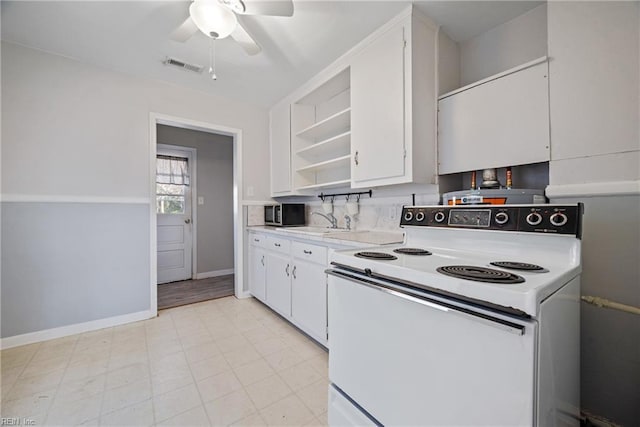 kitchen featuring white range with electric cooktop, white cabinetry, and ceiling fan