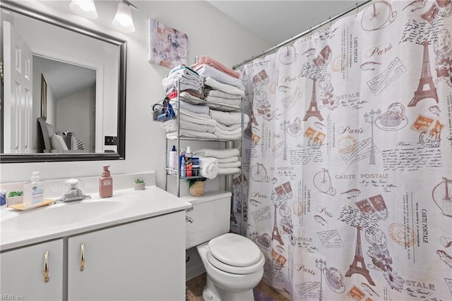 bathroom with vanity, toilet, and walk in shower