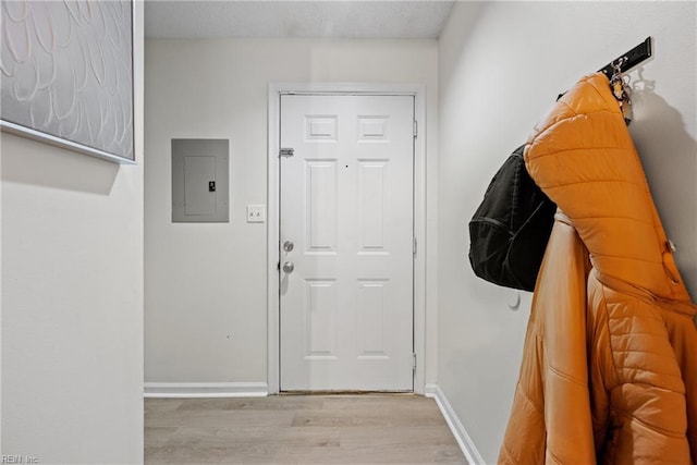 doorway with electric panel and light hardwood / wood-style floors