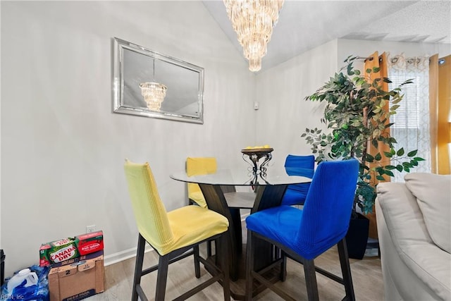 dining room with wood-type flooring and a notable chandelier