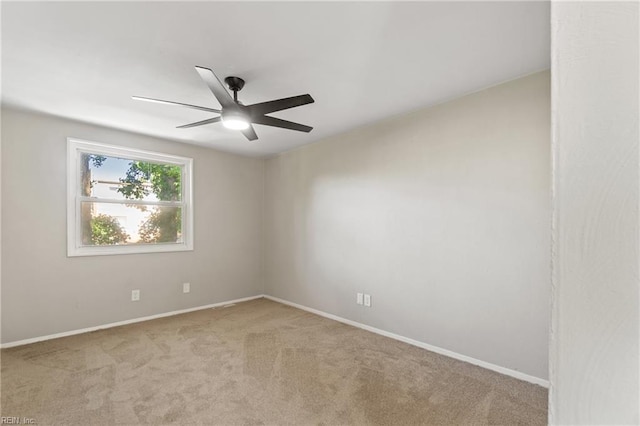 carpeted empty room featuring ceiling fan