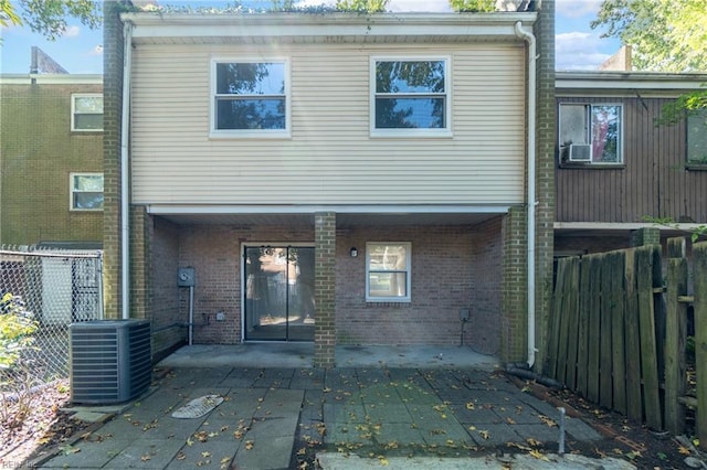 back of property featuring central AC unit and a patio