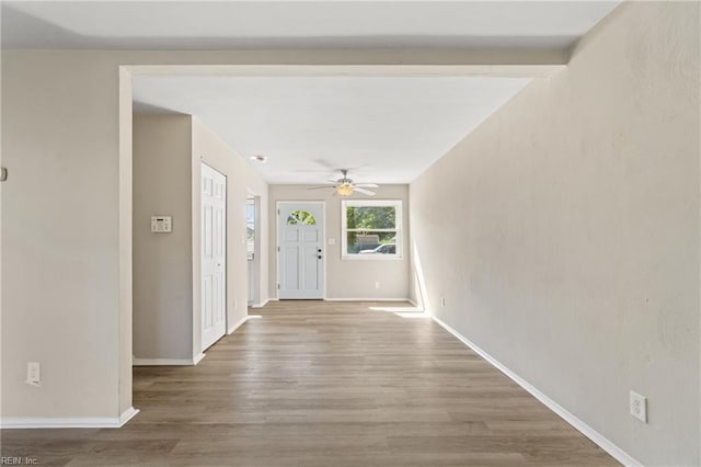 entryway with beam ceiling, hardwood / wood-style flooring, and ceiling fan