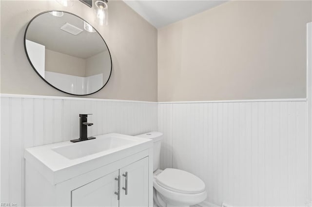 bathroom featuring vanity and toilet