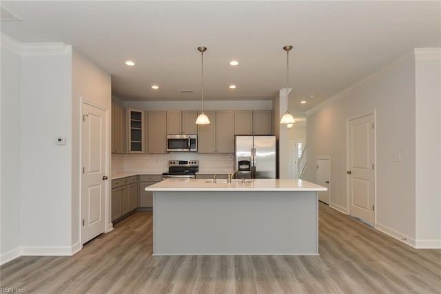 kitchen with stainless steel appliances, backsplash, hanging light fixtures, a kitchen island with sink, and crown molding