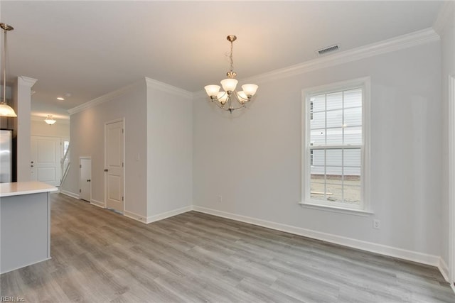 interior space featuring ornamental molding, light hardwood / wood-style floors, and an inviting chandelier