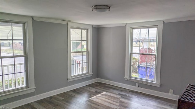 unfurnished room featuring crown molding and dark hardwood / wood-style flooring