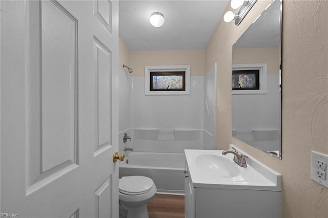 bathroom with hardwood / wood-style flooring, vanity, and toilet