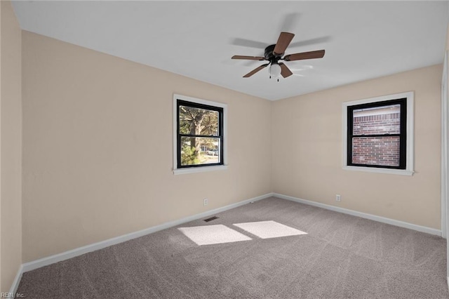 spare room with light carpet and ceiling fan