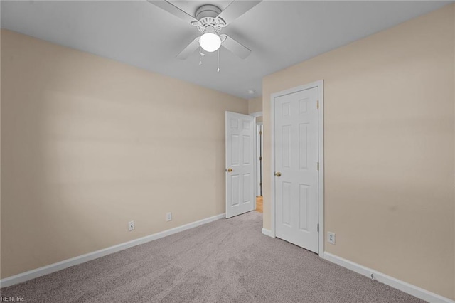 unfurnished bedroom with ceiling fan and light colored carpet