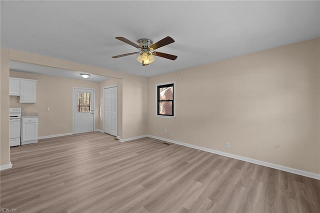 unfurnished living room featuring ceiling fan and light hardwood / wood-style floors