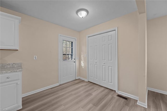 foyer entrance with light wood-type flooring