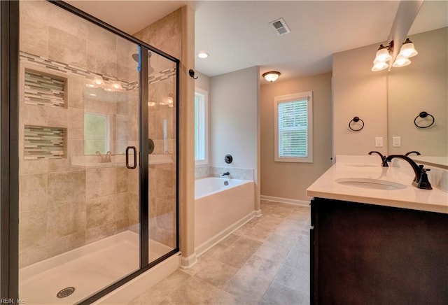 bathroom featuring vanity and shower with separate bathtub