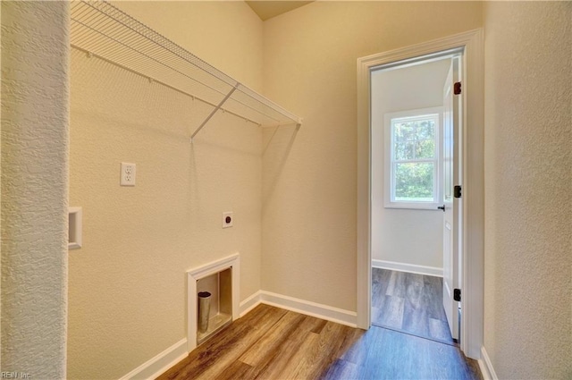 clothes washing area with hardwood / wood-style flooring and electric dryer hookup